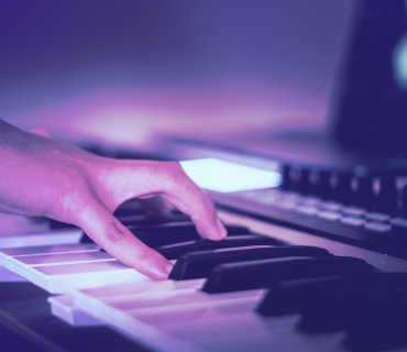 Close up of hand playing keyboard